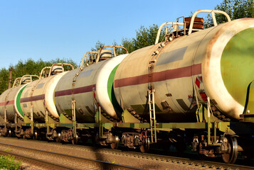 Transport tank car LNG by rail, gas - oil products. LPG transport propane. The fuel train, rolling stock with petrochemical tank cars. Liquefied natural gas and crude export. Shipping petroleum
