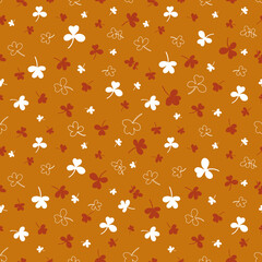Seamless pattern with clover leaves.Magical plant. Background for St. Patrick's Day. Brown endless backdrop with trefoils and quatrefoils.