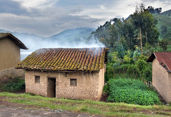 Rubavu, Rwanda: smoke comes through a roof, caused by  indoor cooking on open wood fire 