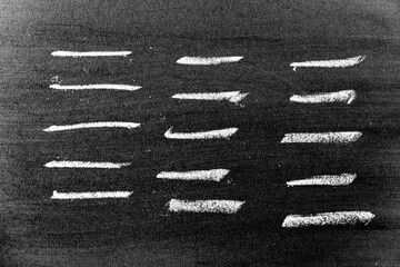 White color chalk hand drawing in set of line or square shape on black board background