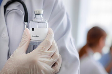 close up a bottle of vaccine in doctor ’s hand at hospital. Medical treatment data collection.