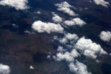 Aerial view of the countryside from above the clouds © Alin Ciurca/Wirestock