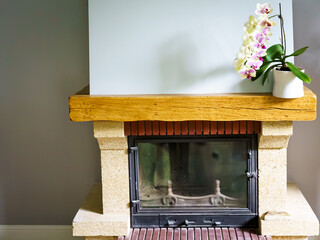 French-style wood-burning fireplace with white orchid