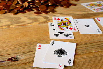 Four aces cards , poker on a wooden table .