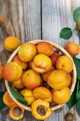 Apricots in a basket on wooden boards, top view down. Fresh fruit concept