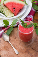 Watermelon smoothie garnished with fresh mint leaves - refreshing drink ideal for hot summer days.