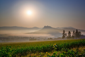 Spis Zipser Castle above valley at sunset or sunrise