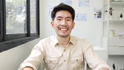 Screen of Asian businessman talking while video call or virtual meeting in office, front view look at laptop web camera
