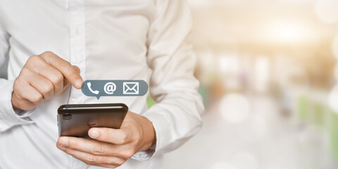 CONTACT US, Businessman hand holding mobile phone with ( address, phone, email ) icon. Concept of customer service call center.