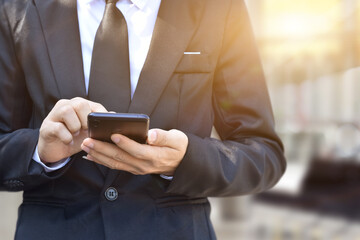 Closeup of businessman hand using mobile phone. Idea for business, technology and online marketing.