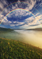 Fototapeta na wymiar Beautiful landscape with a rainbow in the sky