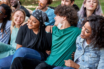 beautiful tolerant mixed race young people gathered together to show that friendship has no race. african american and caucasian people make love, not war