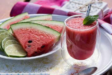 Watermelon smoothie garnished with fresh mint leaves - refreshing drink ideal for hot summer days.