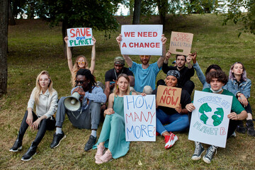 young diverse people protest with placards and posters on global strike for climate change. save our planet from plastic pollution
