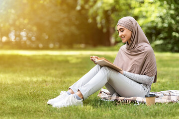 Relaxed muslim woman enjoying weekend at park © Prostock-studio