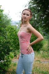 Fototapeta premium The beautiful girl is walking outdoors. Girl in the park. Girl on nature. Woman outside. Positive woman smiling
