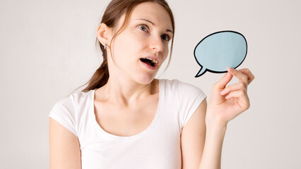 woman holding blank speech bubble on white background