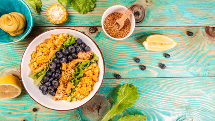 Fresh Chicken salad with corn, lemon, mustard blueberries. healthy food concept, catering