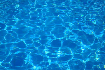 Pure blue water in the pool, pond. Water background for recreation and summer vacation. Natural...