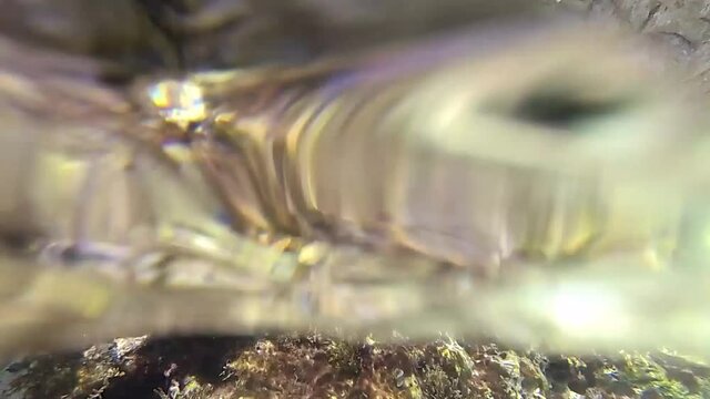 the waves climb along the rock taken below the surface of the sea 