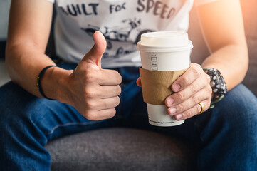 man holding recycle cup