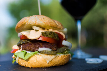 Homemade burger served in a garden.