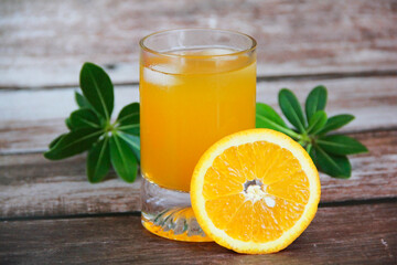 orange drink in a glass and slices of natural orange