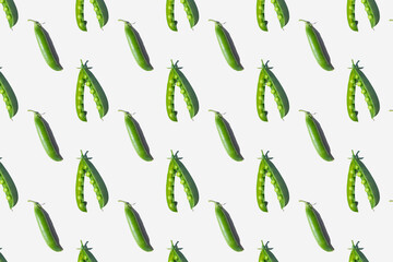 Pattern of peas in pods on a light background. The concept of healthy vitamin food, detail, crop, vegetarianism.