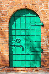 Iron door in a brick wall of one of the most ancient buildings of Russia, Uglich, Yaroslavl region