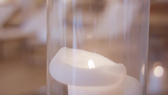 burning candle with a flickering flame inside a glass. 4K ProRes Footage