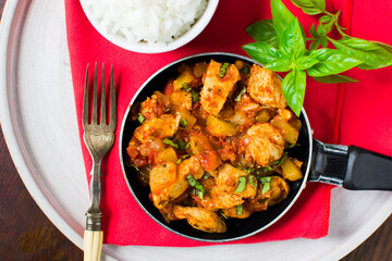 Chicken, tomato and zucchini sauce served with rice.