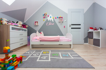 Children bedroom for a boy and a girl with painted mountains on the walls