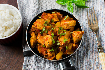 Chicken, tomato and zucchini sauce served with rice.