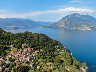 beautiful village at lake como during summer aerial panorama between dervio and bellano with lake and mountains in background