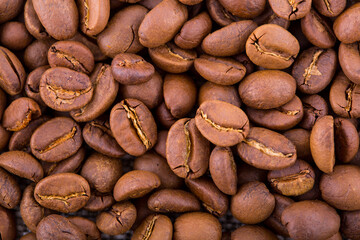 Background and texture of a scattering of roasted coffee beans