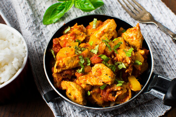 Chicken, tomato and zucchini sauce served with rice.