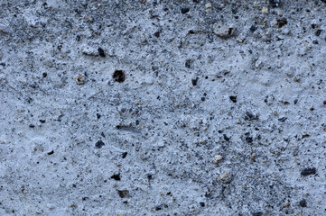 Gray background. Rusty concrete surface. The gravel in the cement, the pebbles.