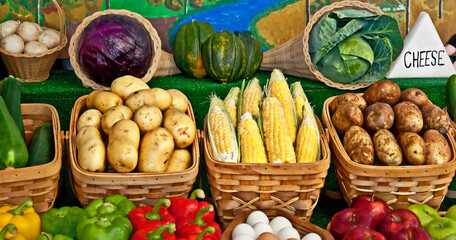 This still life is many vegetables in baskets and some fruits, for fresh, healthy produce.  There are potatoes, corn on the cob, zucchini, bell peppers, apples, eggs, mushrooms, squash, and purple and