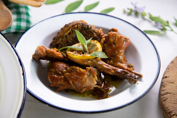 Wild rabbit cooked with lemon and salvia