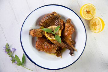 Wild rabbit cooked with lemon and salvia