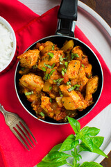 Chicken, tomato and zucchini sauce served with rice.