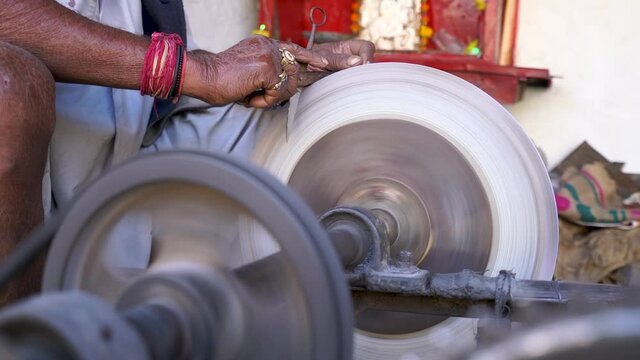 Person Sharpening Scissors Using A Grinding Wheel In The Street Of Jaisalmer City, Rajasthan, India.  - medium shot