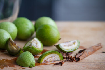 Step-by-step recipe for preparing Italian liquor nocino from green walnuts at home, real home kitchen and cooking, selective focus