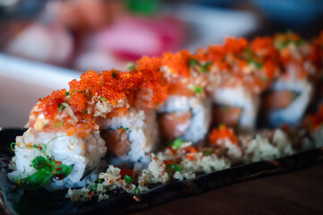 California roll topped with fresh salmon and salmon roe served on crispy shrimp.