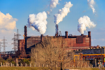 View of old factory with pipes with smoke. Air pollution, environmental damage