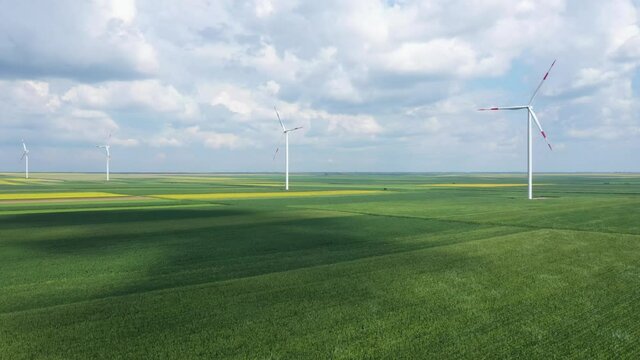 Aerial view of wind turbines on modern wind farm from drone pov