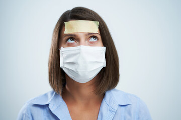 Attractive woman wearing protective mask isolated over white background