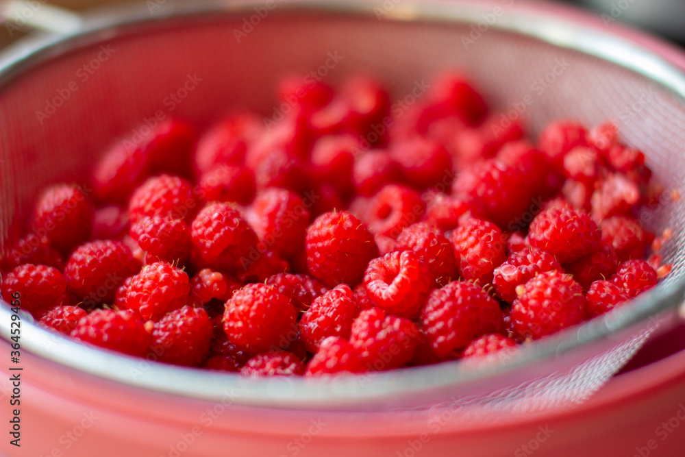 Poster red raspberry berry in a bucket. the view from the top