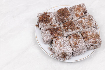 Square Chocolate cookies with coconut served on the plate