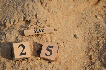 May 25, Number cube with Sand pile for a background.